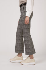 Model zeigt karierte Hose der Marke Cambio und Sneaker der Marke Voile Blanche.