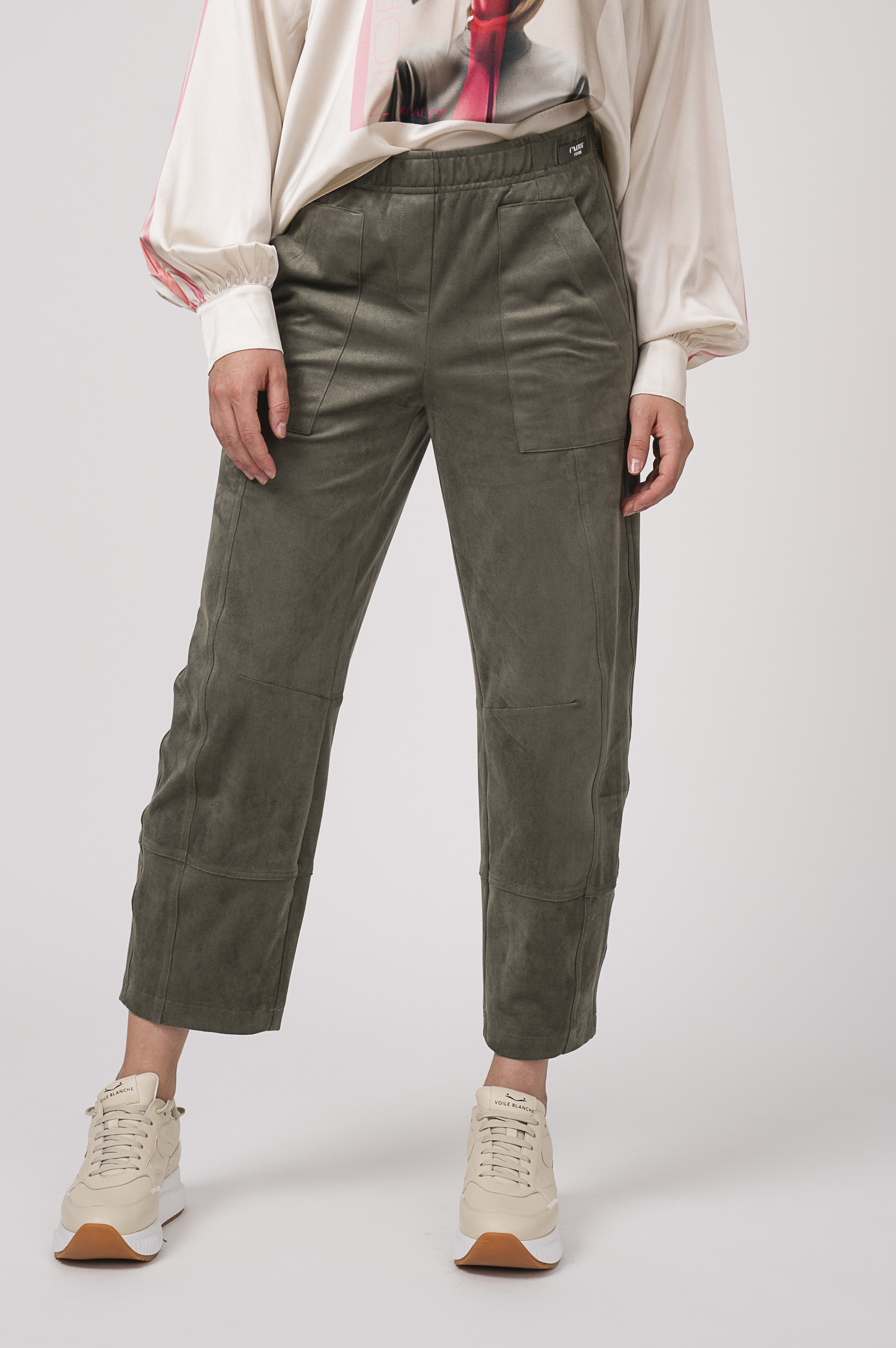 Model zeigt olivgrüne Hose der Marke Cambio und Sneaker der Marke Voile Blanche.