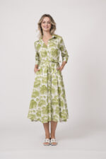 Model trägt ein langes Kleid der Marke Rossana Diva, mit grünem Muster.