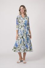 Model trägt ein langes Kleid der Marke Samantha Sung mit blauem, grünem und weißem Blumenmuster.