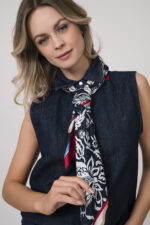 Model trägt eine dunkelblaue ärmellose Jeansbluse der Marke 7 for all mankind und ein rot, weiß dunkelblaues Tuch von Joop!