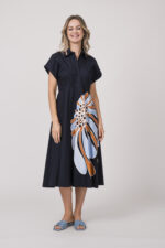 Model trägt ein dunkelblaues Kleid mit Kragen und Blumenmuster der Marke Dorothee Schumacher.