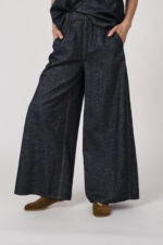 Model trägt ein denim Kurzarmshirt der Marke Susanne Bommer, dazu die passenden Jeans der Marke Susanne Bommer.