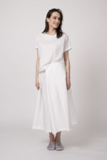 Model trägt ein weißes Oberteil und einen weißen Rock der Marke MeiMeij.