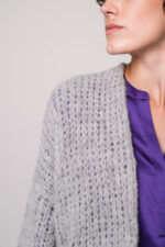 Model trägt eine graue Weste der Marke Michele & Hoven, eine violette Bluse der Marke Herzens