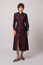 Model trägt ein weinrotes Kleid der Marke Rosso35.
