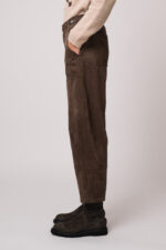 Model trägt eine braune Hose der Marke Cambio.