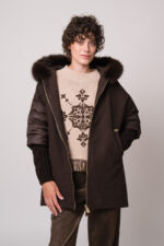 Model trägt eine braune Jacke der Marke Marco dele Forte, einen braun gemusterten Pullover der Marke Grace und eine braune Hose der Marke Cambio.