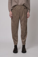 Das Model trägt einen Stehkragenpullover von Hemisphere in Sand, dazu eine Cordhose von Cambio in Camel.