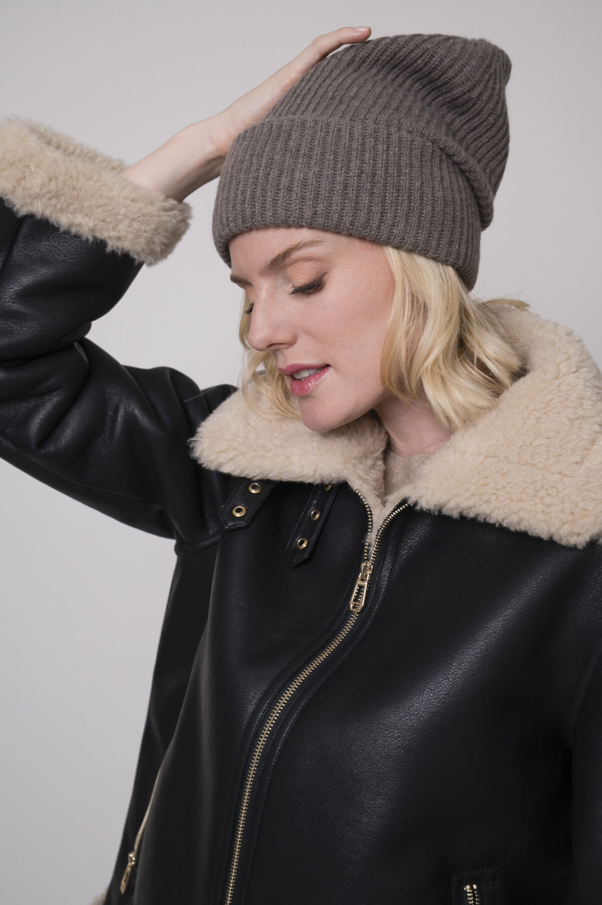 Das Model trägt eine Jacke in schwarz der Marke Joop, eine Haube der Marke FFC.